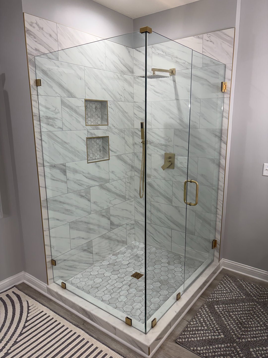 Frameless Glass Shower with Brushed Gold Hardware in Westerville, OH