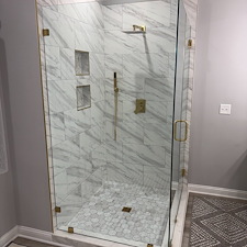 Frameless-Glass-Shower-with-Brushed-Gold-Hardware-in-Westerville-OH 1